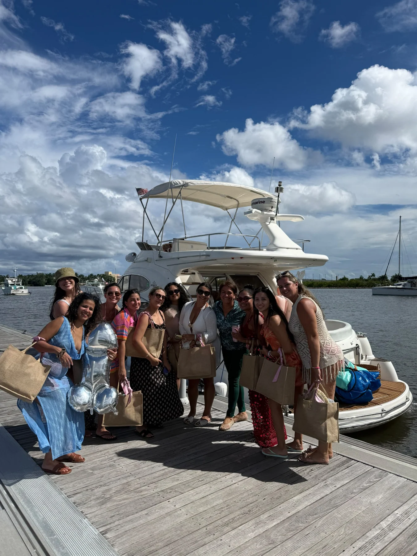 A group gathered beside a Tourism Joaquin yacht before their outing