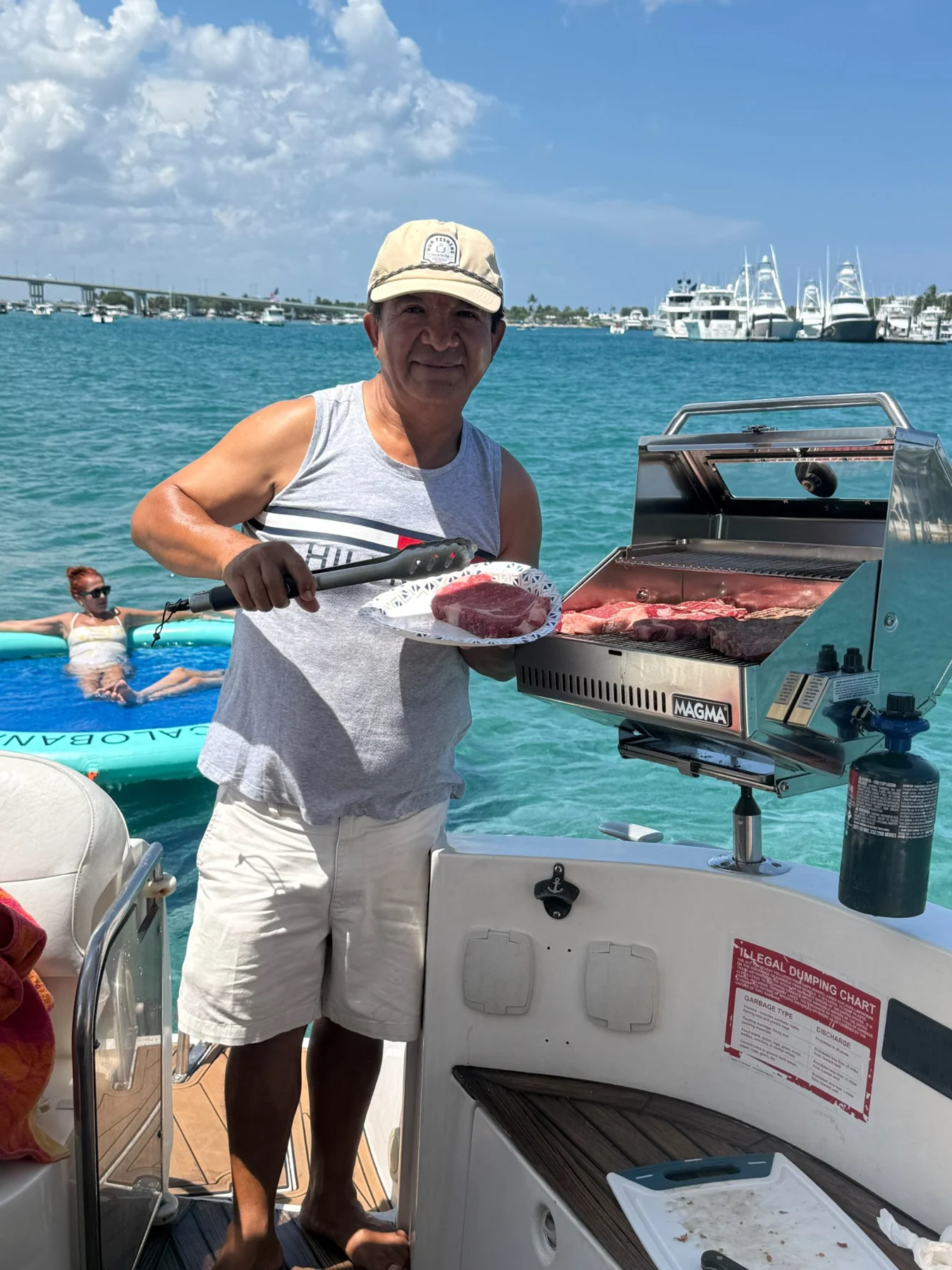 A guest preparing food on an onboard grill