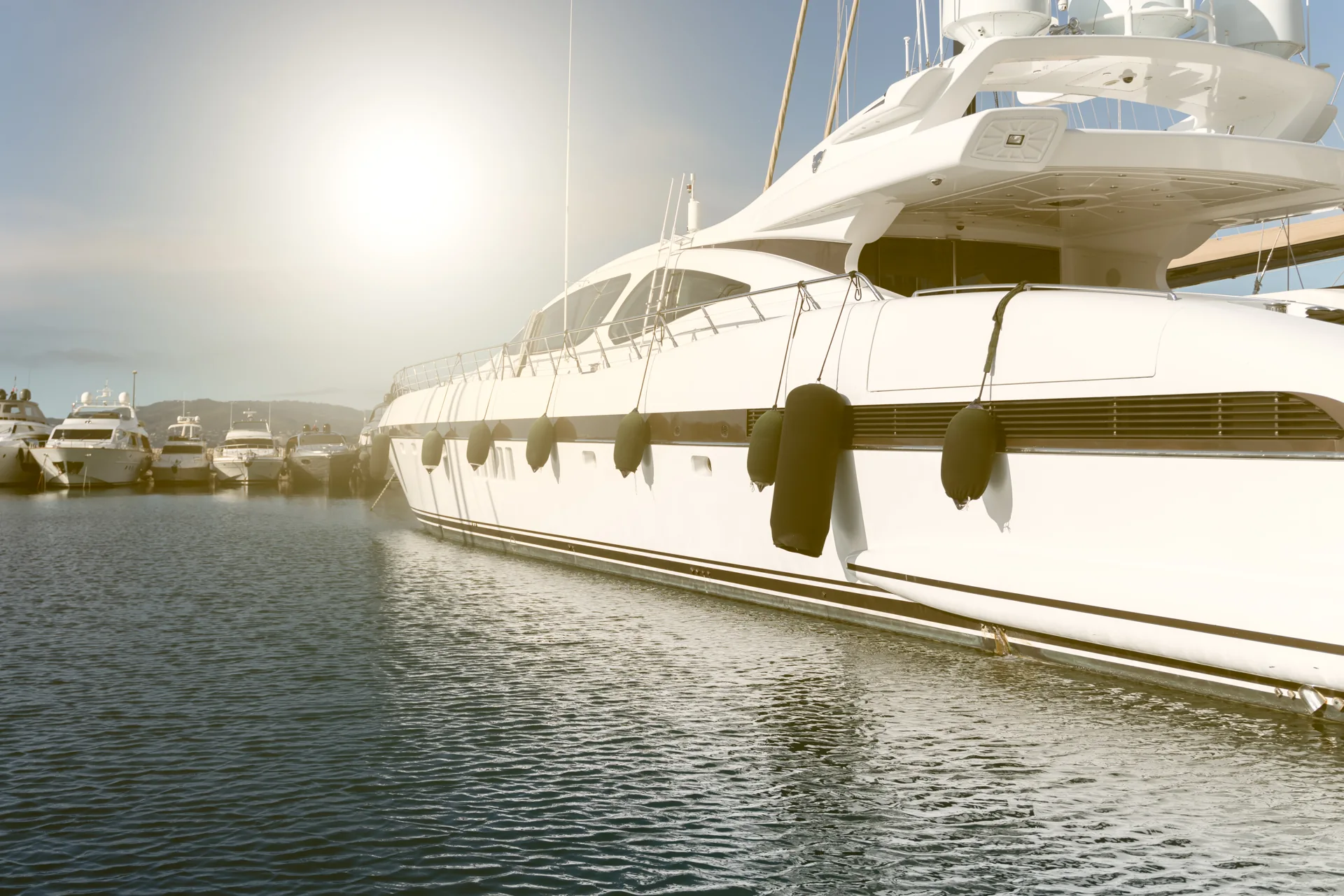 Sunlight shining on a yacht in a marina